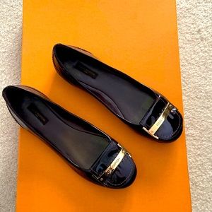 Authentic Bordeaux patent leather Louis Vuitton flat with gold hardware.
